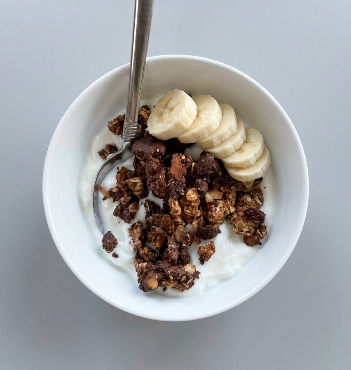 Clean Power Granola in a bowl with yogurt and banana